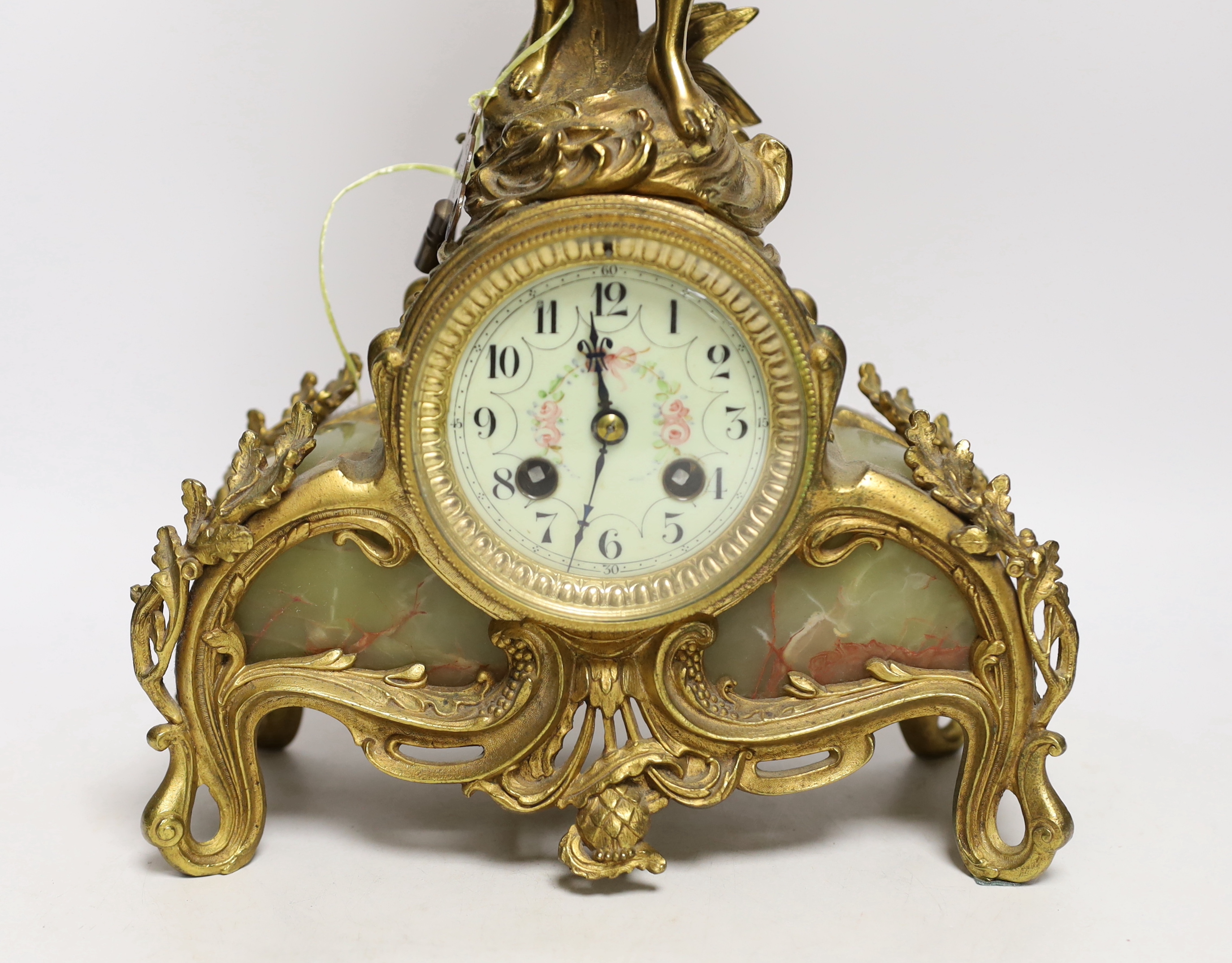 A French figurative gilt metal and green onyx mantel clock with hand painted dial, 51cm high